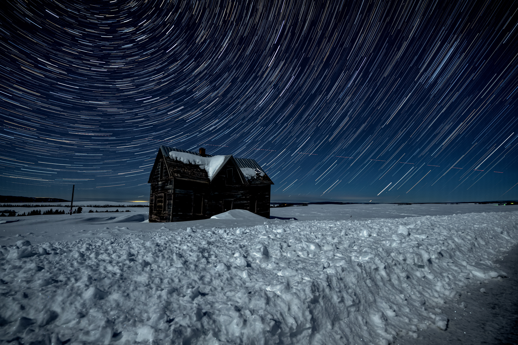 Star trails over historic cabin